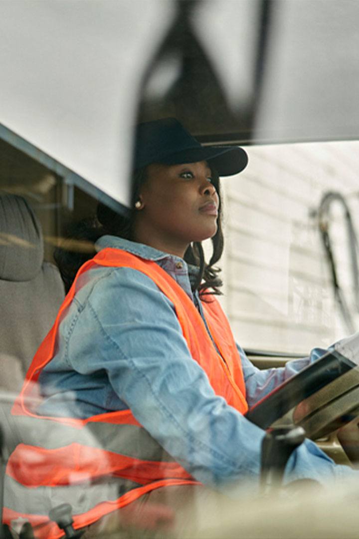 Logistics field service team female delivery driver in his-vis ppe