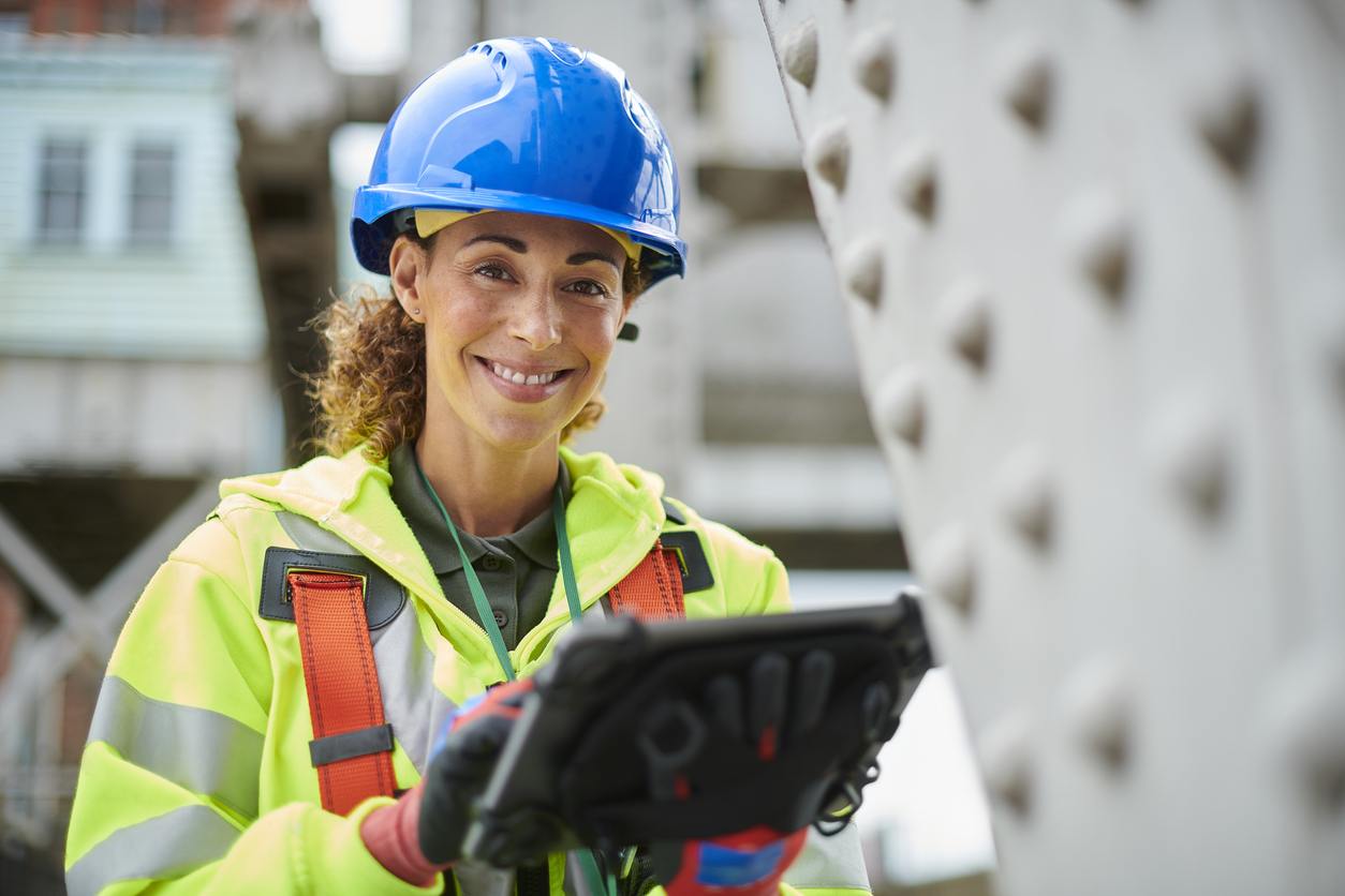 Female telecommunications service engineer in hi-vis PPE